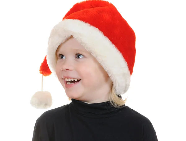 Het kind in een hoed santa claus — Stockfoto