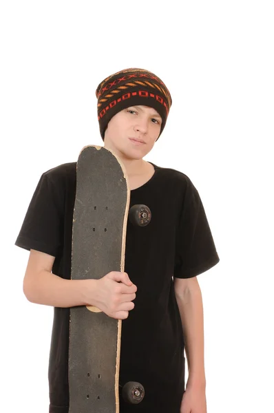 O adolescente com um skate — Fotografia de Stock