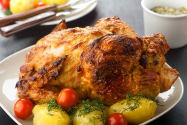 baked chicken leg with vegetable and potato close up 