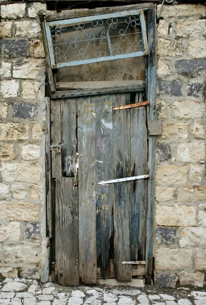 Grunge door in old stone house — Stock Photo, Image