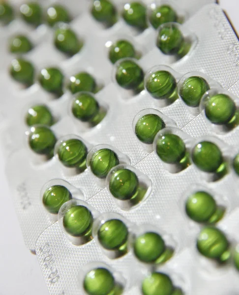 Green pills background — Stock Photo, Image