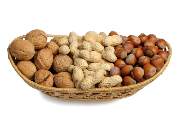 Set of nuts in a wicker basket, isolated — Stock Photo, Image