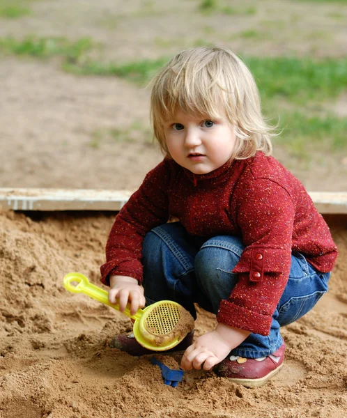 stock image Child plays with sand