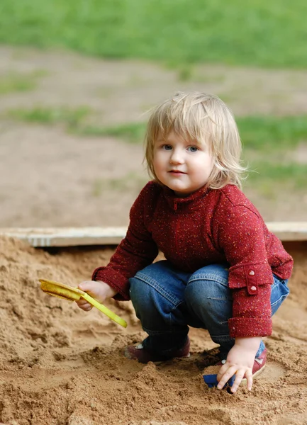 Stock image Child plays with sand