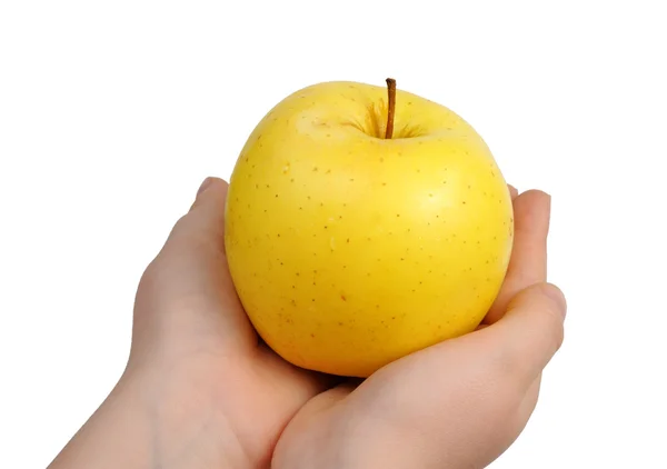 Gelber Apfel zur Hand — Stockfoto