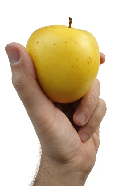 Žluté jablko v ruce — Stock fotografie