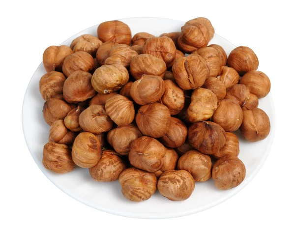 Hazelnuts on a white plate, isolated. — Stock Photo, Image