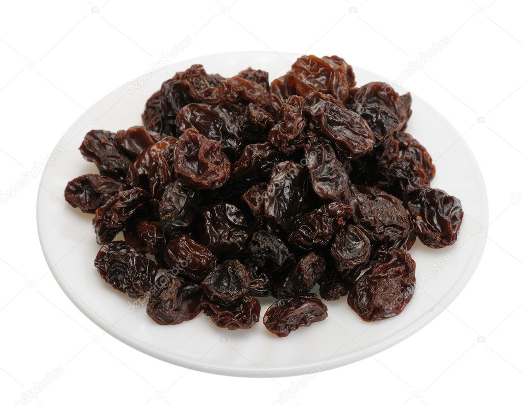 Raisin on a white plate, isolated