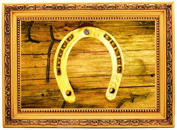 Gold horseshoe op een oude houten — Stockfoto