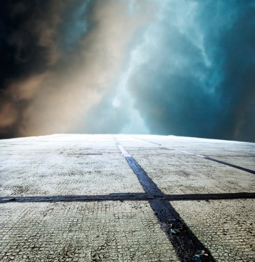 concrete wall with a cloudy sky and the sun 