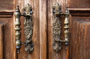 old door knocker in a wooden door  clipart