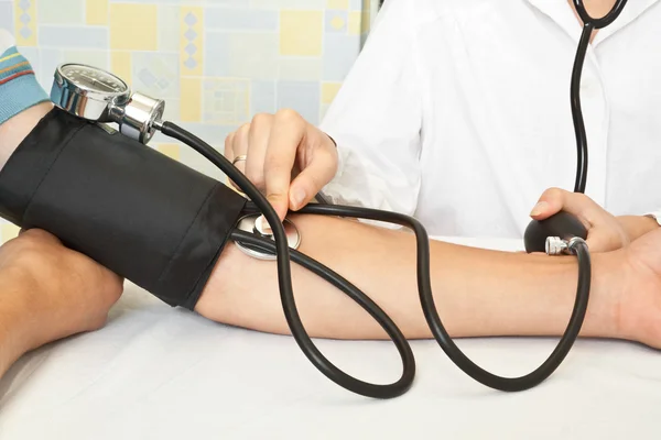 Doctor Checking Blood Pressure Stockfoto