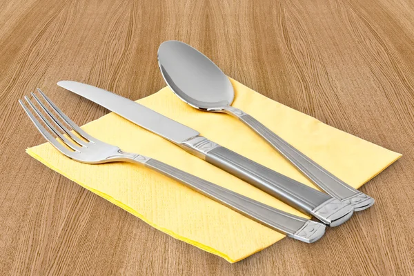 Mes, vork en lepel op tabel-servet — Stockfoto