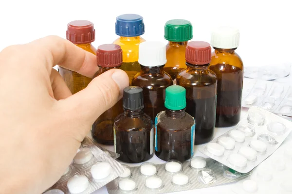 Mão com frascos de medicamentos e comprimidos — Fotografia de Stock