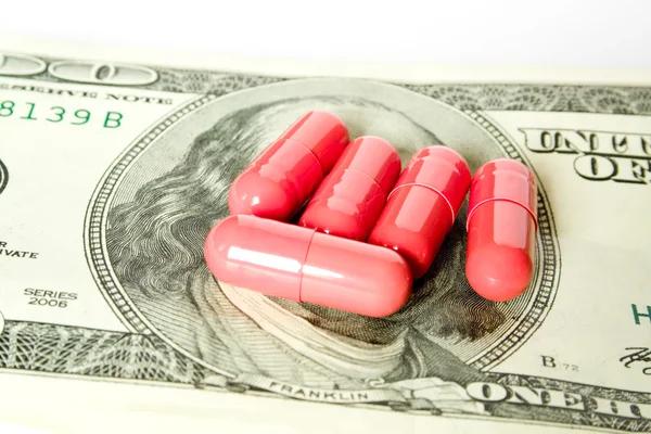 Pill on money — Stock Photo, Image