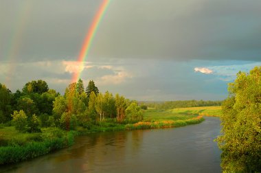 Rainbow above the river clipart