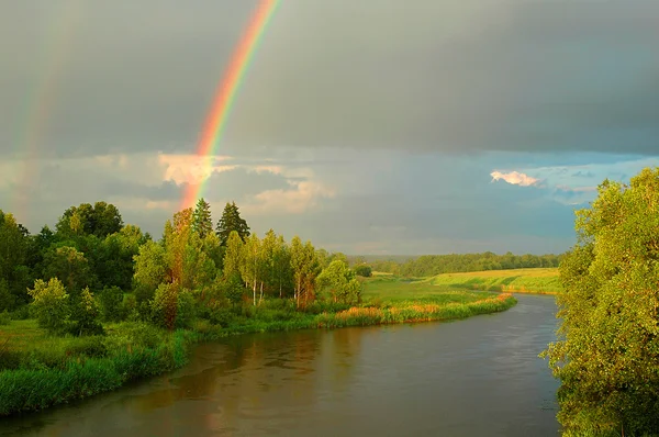 Rainbow above the river — Stock Photo, Image