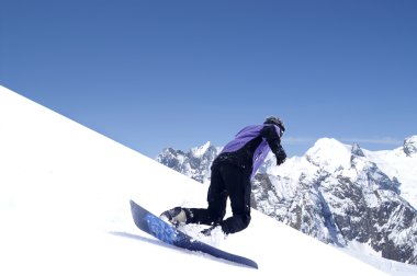 Snowboarder in Caucasus Mountains clipart