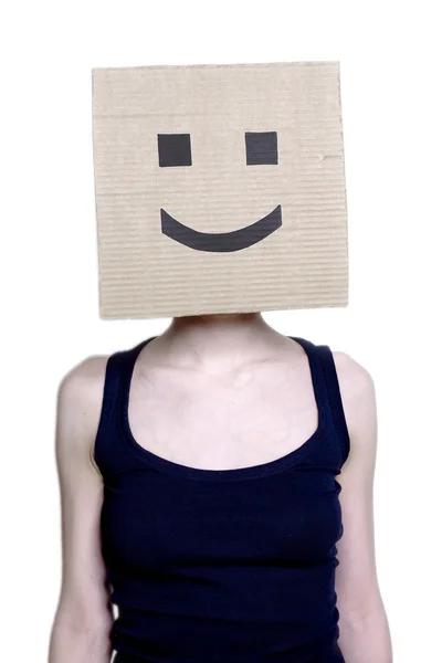 stock image Girl in a cardboard mask with a smile