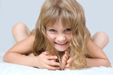 little girl lying on white  clipart