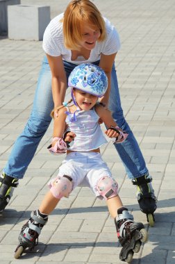 mother and daughter roller skating  clipart