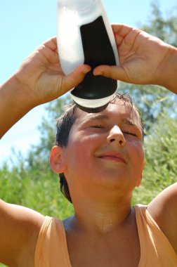 young boy taking selfie with his phone in the summer  clipart