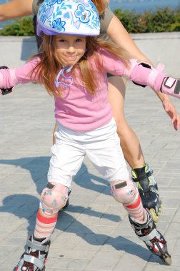 little girl on skates in park  clipart