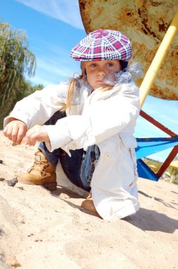 cute girl in a hat and a jacket in the desert 