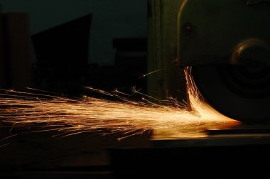 sparks from metal cutting machine in the factory 
