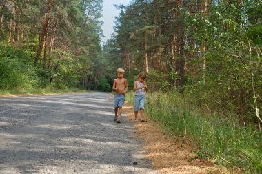 two young women walking along the road  clipart