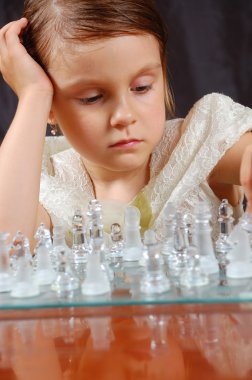 little girl playing chess  clipart