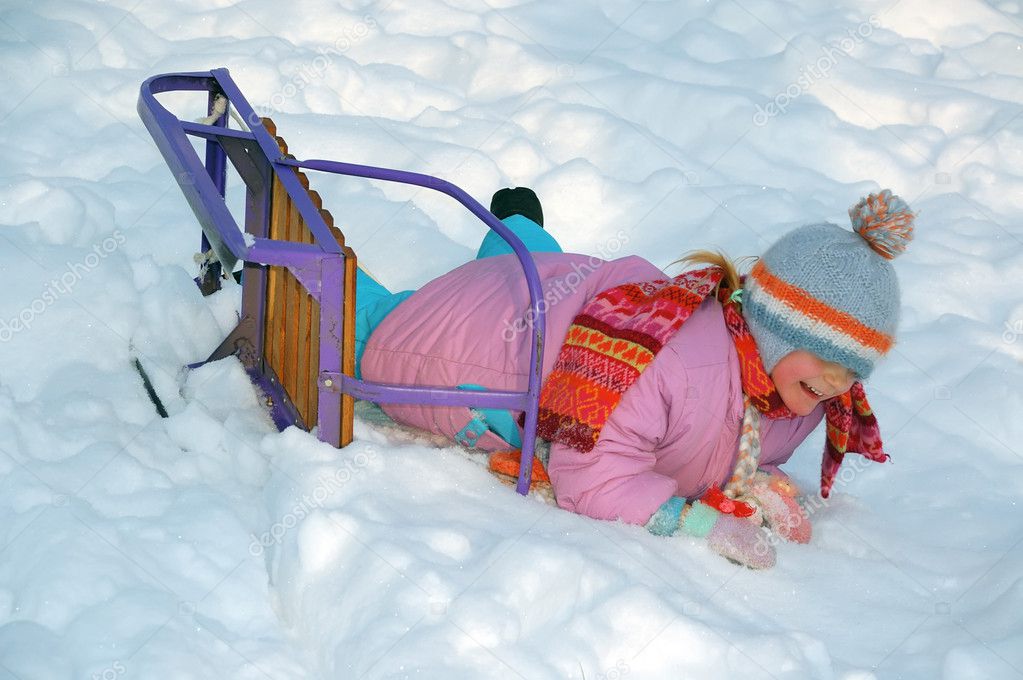 little girl on sled in winter 