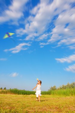 Running child flying a kite clipart