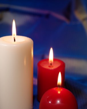 red candles on a blue background, close up 