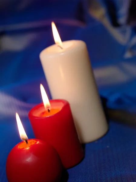 Three Candles Blue Background — Zdjęcie stockowe