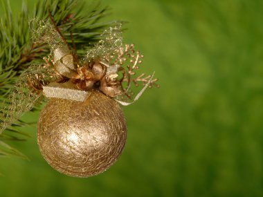 Xmas golden ball on the green background clipart