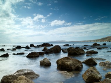 Sleeping sea under the blue sky clipart