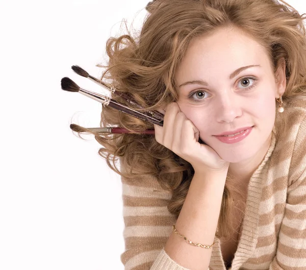 Young girl with brushes in hand — Stock Photo, Image
