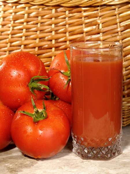 Fresh ripe tomatoes with glass of juice — Stock Photo, Image