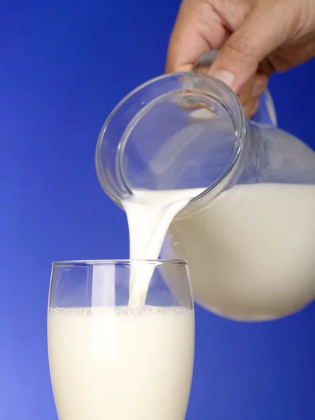 乳白色のストリーム。ガラスとのミルクの水差し — ストック写真