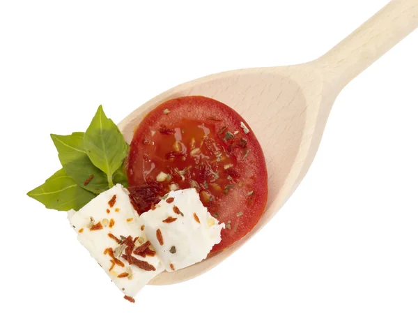 Wooden spoon with feta cheese and vegeta — Stock Photo, Image