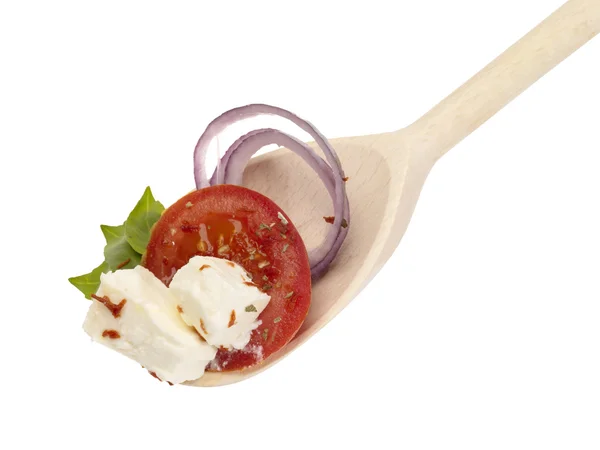 Wooden spoon with feta cheese and vegeta — Stock Photo, Image