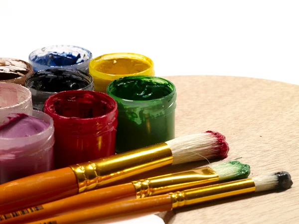 Paintbrushes on the wooden palette — Stock Photo, Image