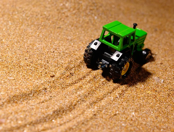 stock image Wheelrd tractor on the new land still-li