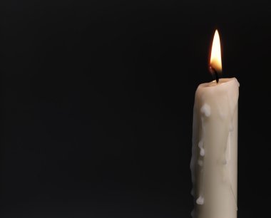 Burning candle over black. Is not isolat clipart