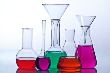 test tubes with colorful liquids in the laboratory on a gray background 