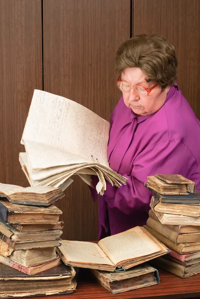 stock image Woman in library with religious books