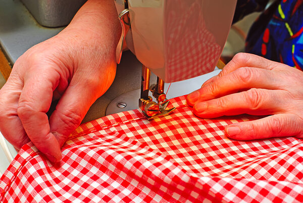 Hands stitching denim cloth