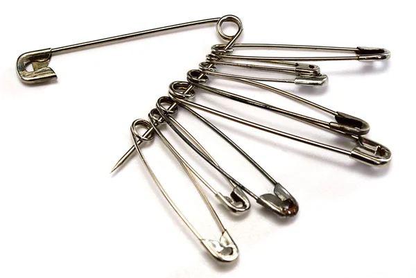 Safety pin in silver over white — Stock Photo, Image