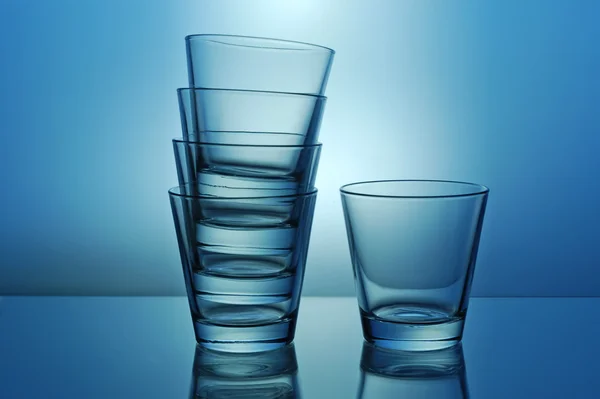 One and stack of glasses — Stock Photo, Image